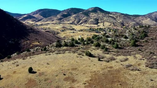 A scenic drone flight over a cliff capturing the small town of Morrison Colorado.