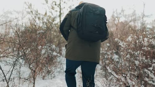 Latino Wanderer Trekking Walking Alone in the Winter Landscape Back View