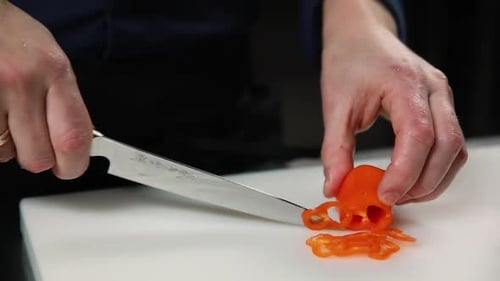 Hands Slice Orange Bell Pepper into Rings
