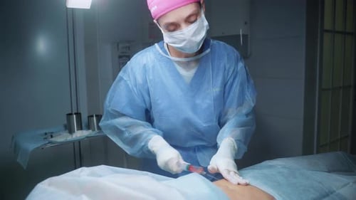 Doctor Performs Procedure in Hospital Operating Room