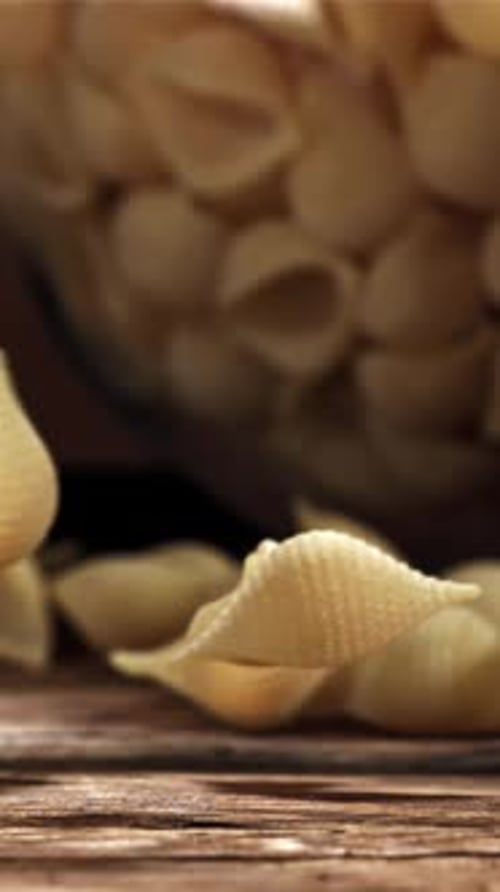 Dry Pasta Falls on a Wooden Table Filmed on a Highspeed Camera at 1000 Fps