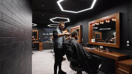 Barber Gives Haircut in Modern Barber Shop