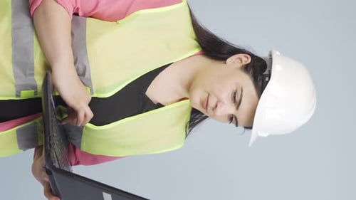 Vertical video of Engineer waving at camera.