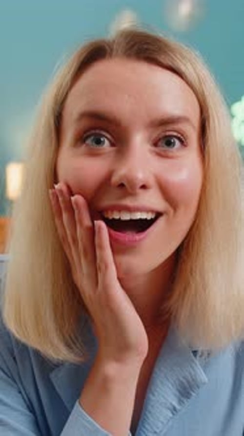 Surprised Young Woman With Open Mouth and Hand on Face