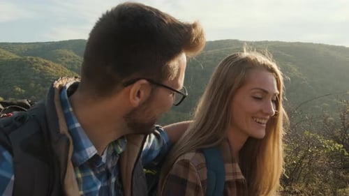 Smiling Couple Hiking in the Mountains