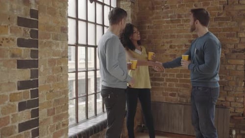 Colleagues meeting and shaking hands in an office