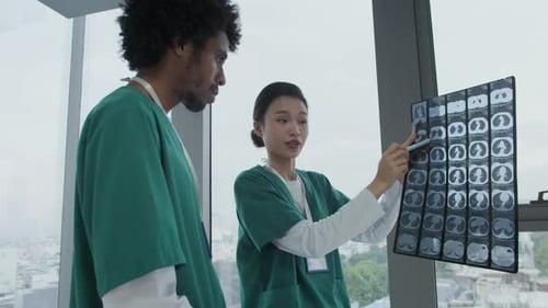 Diverse Doctors Discussing X-ray Image of Patient at Hospital