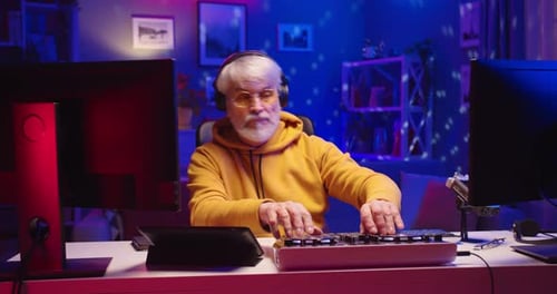 Senior Man Mixing Music with Headphones and Mixer