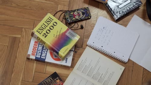 Student Studying English with Books and Notebook