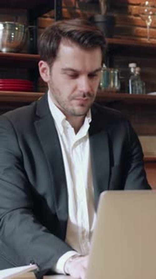 A Professional Man is Working Diligently in a Modern and Contemporary Office Environment