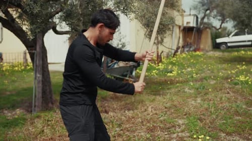 Man Working With Effort Using The Hoe In The Farm