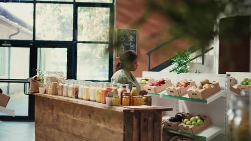 Woman Inspecting Jar of Food in Grocery Store