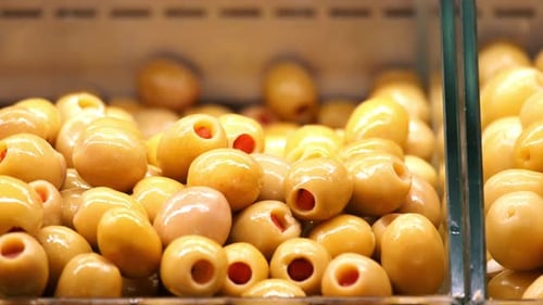 Fresh Green Olives Displayed at Local Market in Afternoon Light