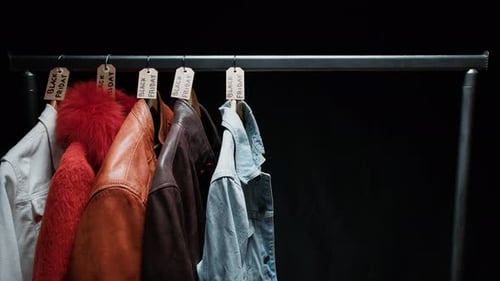 Clothes Hanging in a Shop for Black Friday Composition