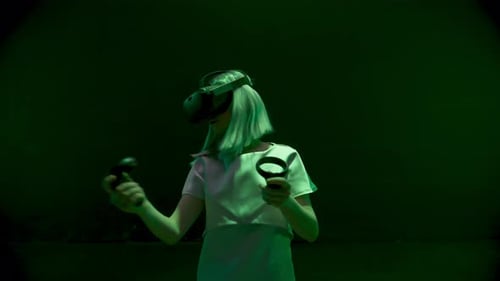 Woman Wearing VR Headset Interacting with Technology in Studio