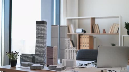 Modern Office Desk with Architectural Model and Laptop Setup