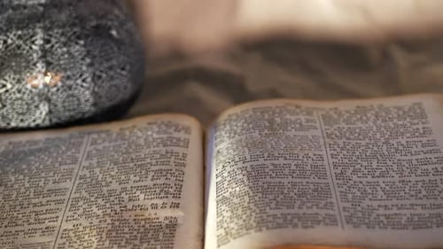 Old Nordic bible with open pages. Tilt upward. Selective focus.