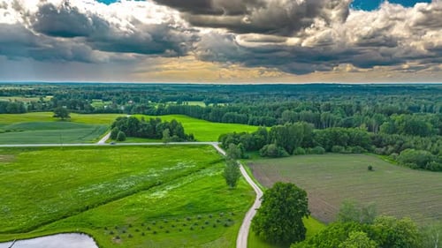 Hyperlapse Of Clouds Above Green Fields And Lake In The Countryside