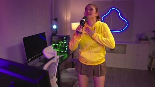 A content creator or streamer singing into a microphone while interacting with the computer screen