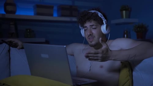 Young man watching sad and drama-themed movies, documentaries.