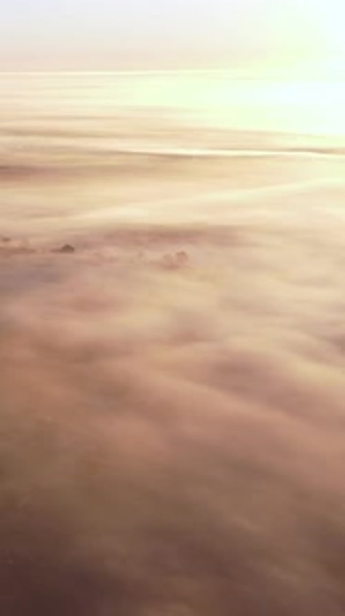 Vertical Video Aerial View Sunrise Flight Over the Morning Fog in the Countryside