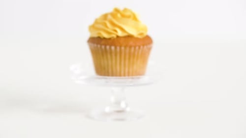Delicious cupcake with yellow frosting on display