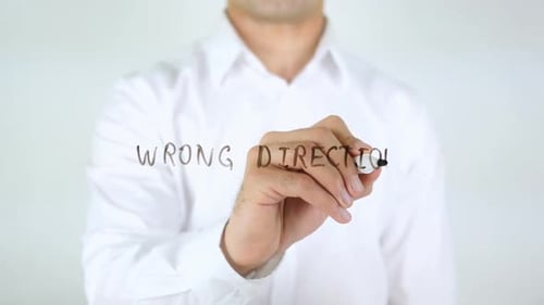 Wrong Direction Man Writing on Glass