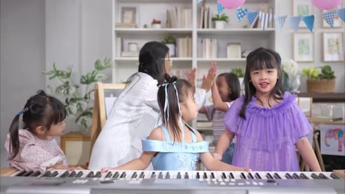 Teacher Giving Piano Lessons to Young Children
