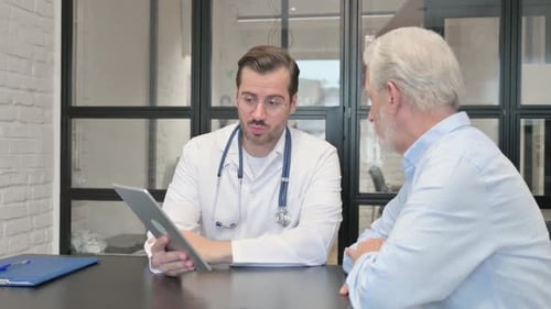 Doctor Showing Tablet to Senior Patient
