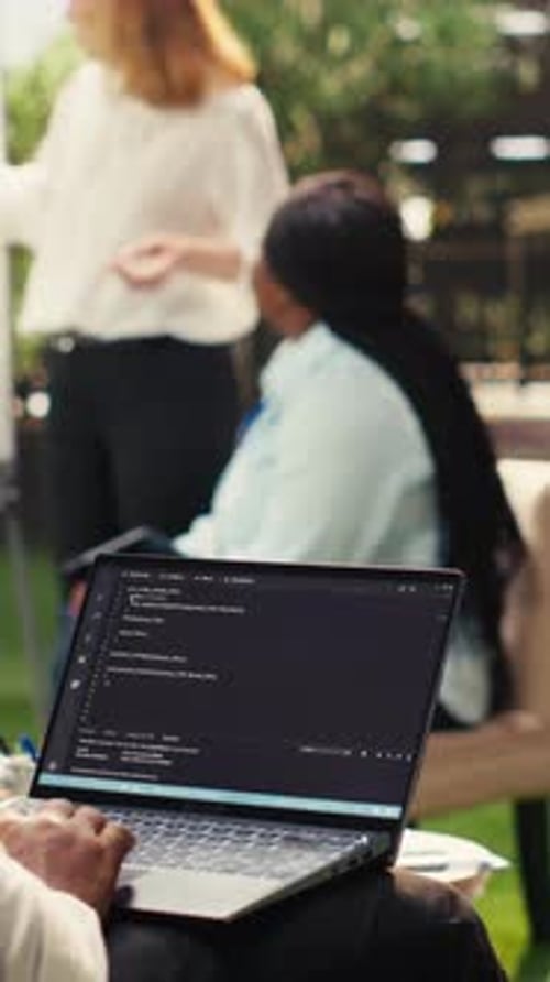 Vertical Video African American Businessman Coding on Laptop Terminal Window on Terrace