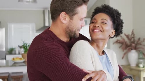 Loving Couple Smiling and Embracing in Their Home