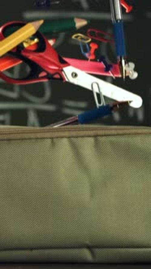 Various Accessories Fall Into the School Pencil Case Filmed on a Highspeed Camera at 1000 Fps