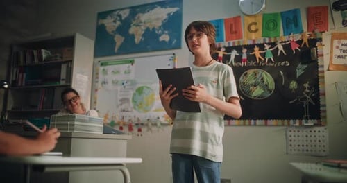 Elementary School Boy Holding Notebook Speaking Giving Presentation on Ecology