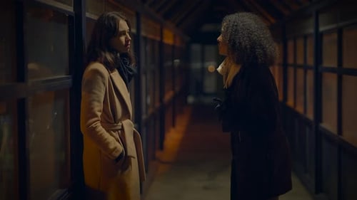 Two Young Women Arguing in Urban Setting at Night