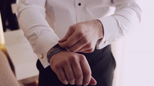Man Fastening Cufflinks on White Dress Shirt