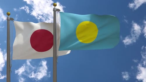 Japan and Palau Flags Waving in the Wind against Blue Sky