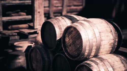 Rustic Wooden Barrels Stacked in an Old Storage Area During Daylight