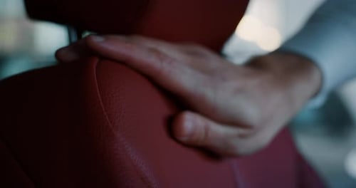 Close up young businessman hand checking an interior of a new anonymous car just bought from auto