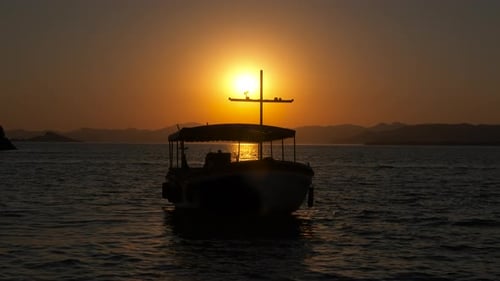 Boat Silhouetted on Water at Golden Sunset