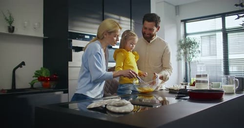 Beloved Caucasian Family Cooking Tasty Dish in Modern Kitchen Happy Woman Explaining Cooking Process