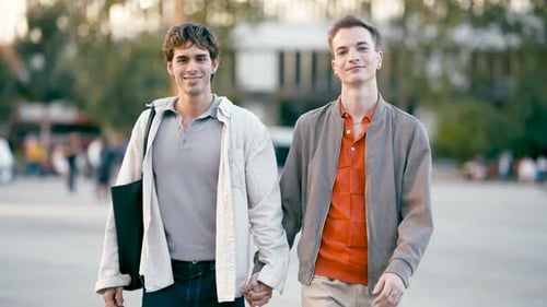Romantic Gay Male Couple Holding Hands and Walking Outdoors