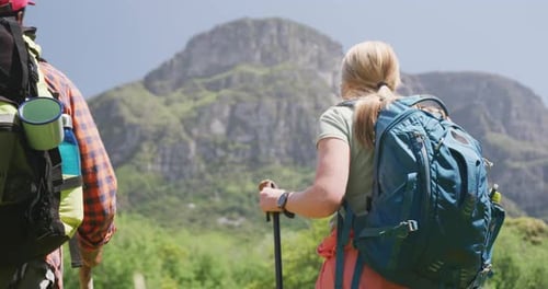 Couple Hiking With Backpacks in Mountainous Nature