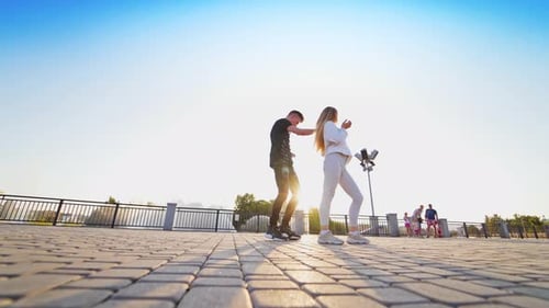 Young dancers moving together. Dancing couple performing contemporary freestyle dance in the street.