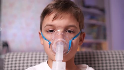 Child Wearing Oxygen Mask with Nebulizer Treatment