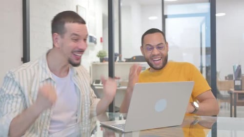 Men Cheering and High Fiving in Office