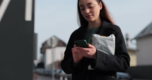 Woman Sending Parcel Via Automated Post Terminal Machine Mail Delivery and Post Service Online