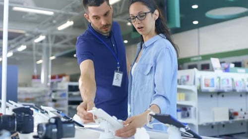 In the Electronics Store Consultant Gives Professional Advice to a Young Woman, She Considers Buyin