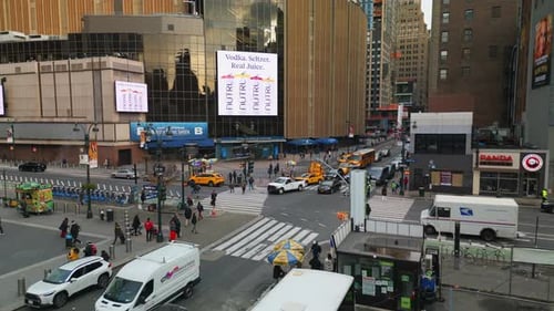 Elevated Shot of Vehicles and Pedestrians on Crossroad at Madison Square Garden in City Centre