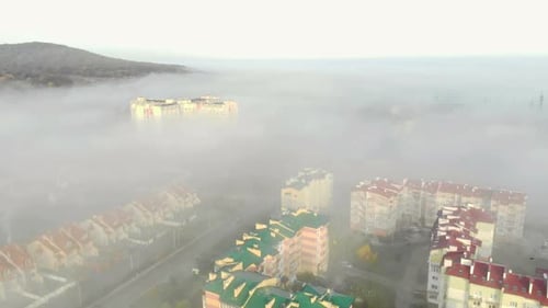 Aerial View at the Houses That are Covered with Morning Fog