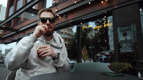 Bearded Man at Cafe Drinking and Vaping